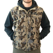 A man wearing a camouflage-patterned zip-up vest over a dark hoodie, shown from the neck down against a plain white background.