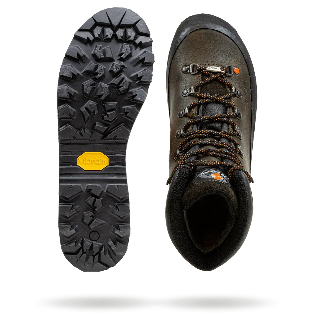 Brown leather hiking boot with metal eyelets and aggressive black rubber sole with deep treads.